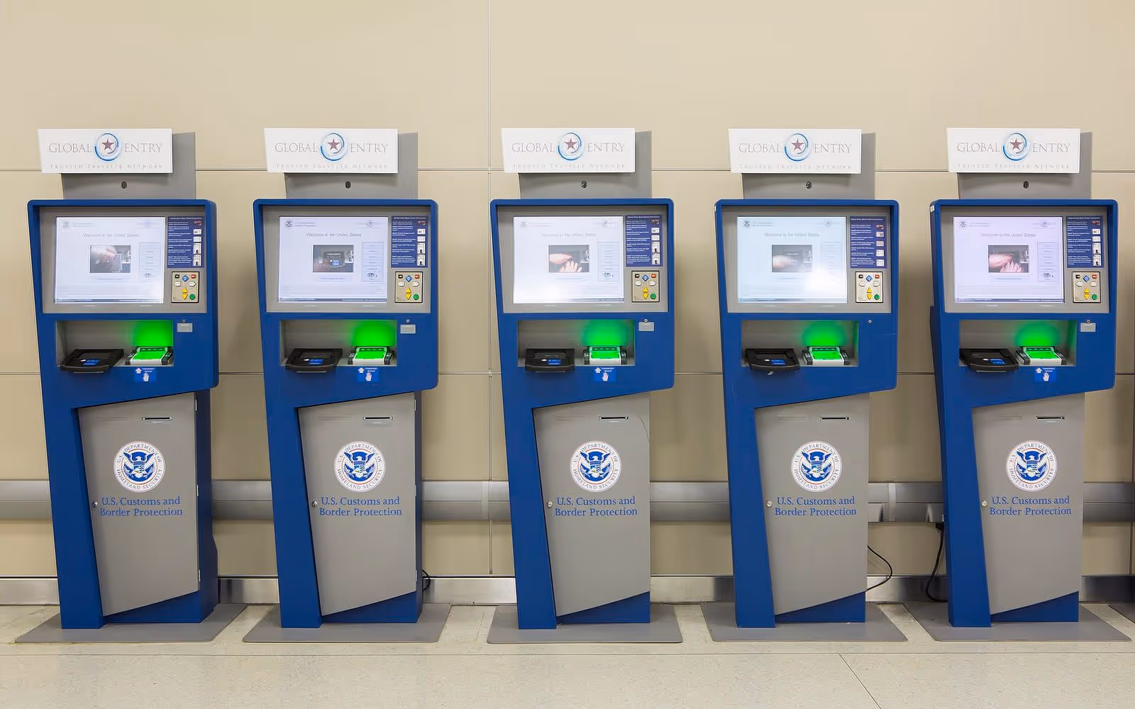A row of automated passport-control kiosks in an airport arrivals hall