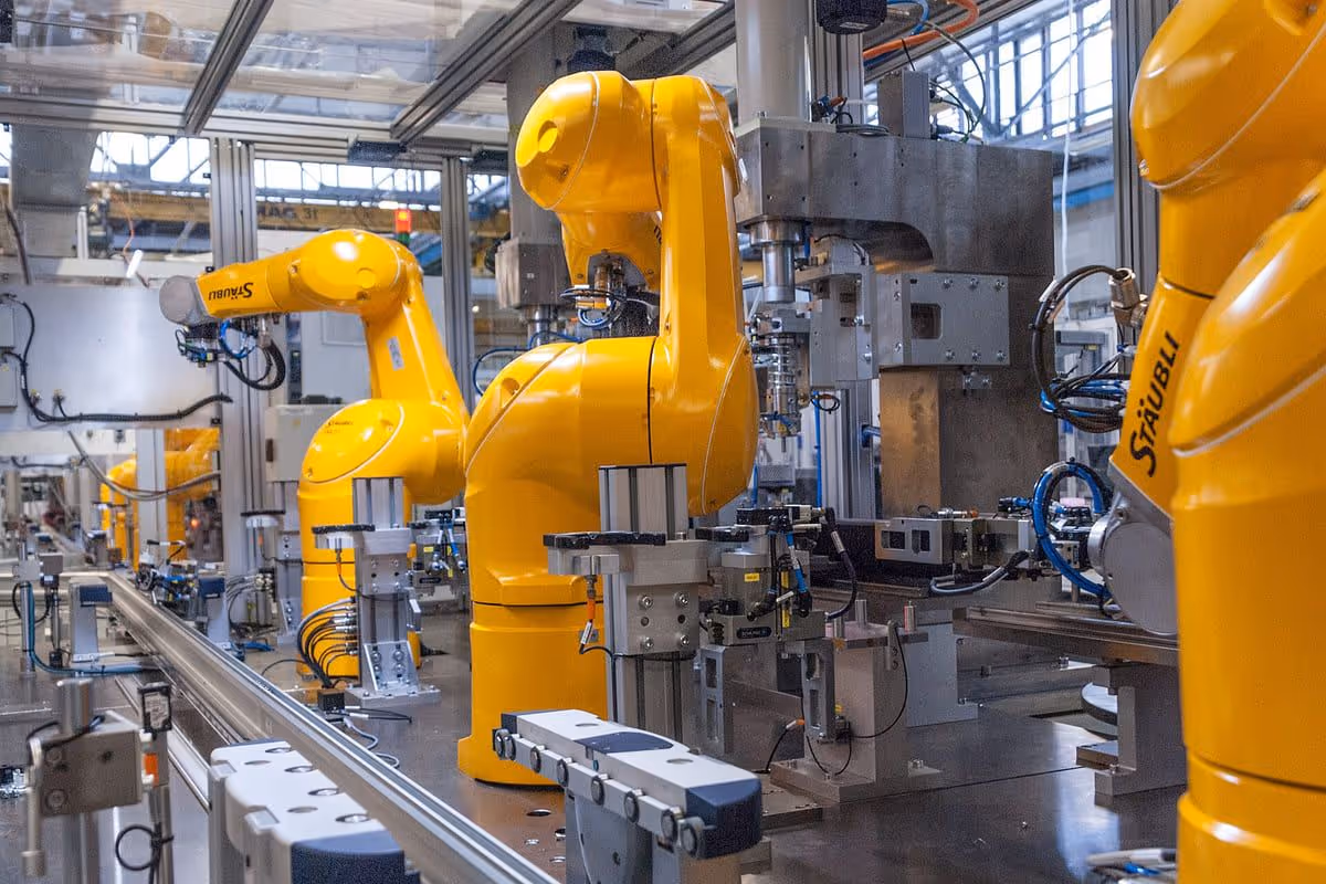 Robotic arms working on an automated assembly line in a factory